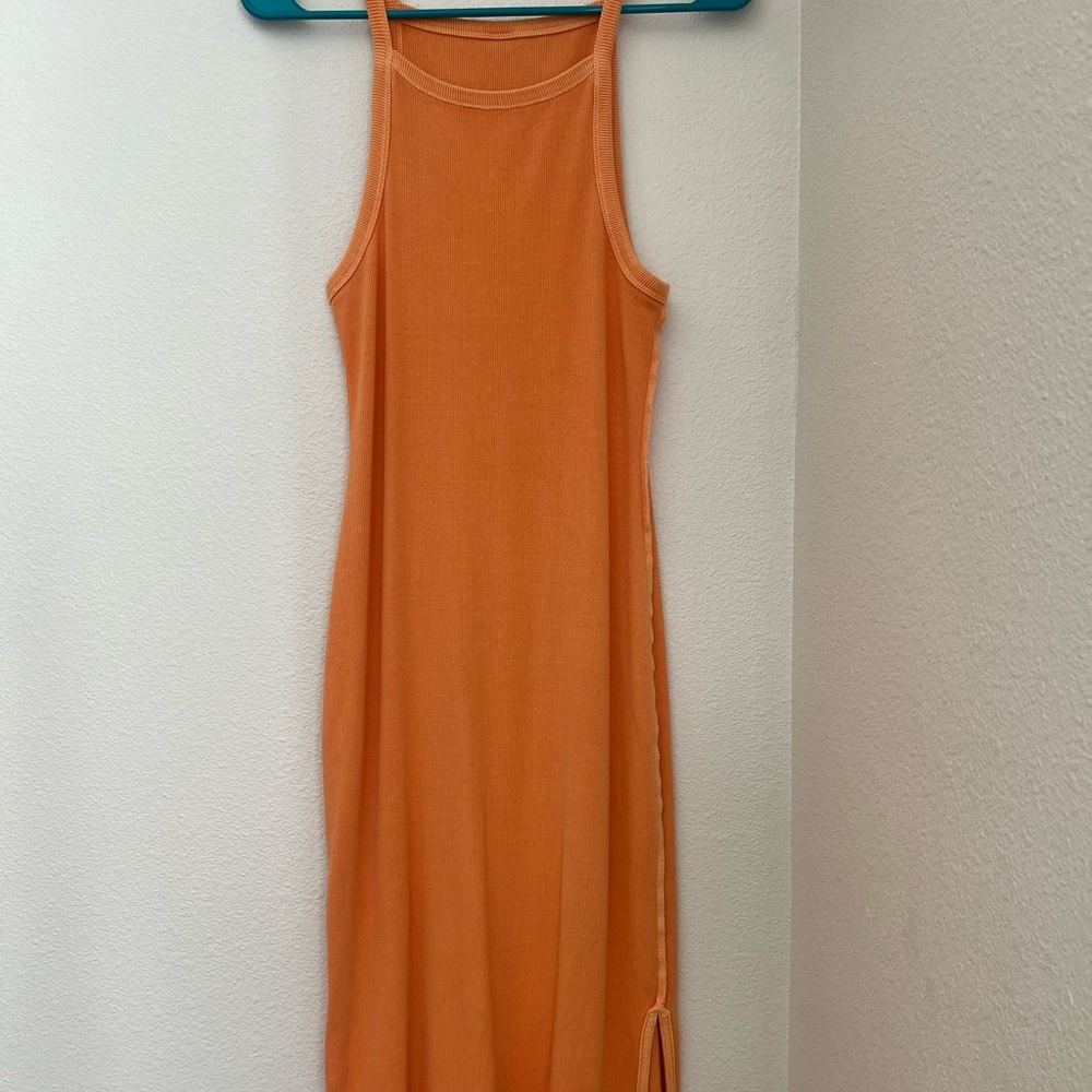 Midi orange tank dress with side slit.